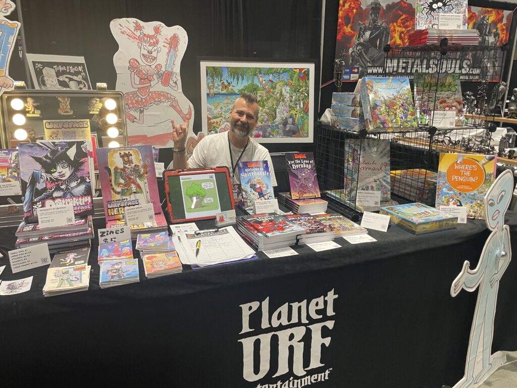 Artist Chuck Whelon at the Planet Urf Entertainment Convention Booth